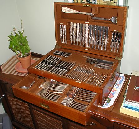 open silver safe with a complete set of knives, forks, spoons, etc