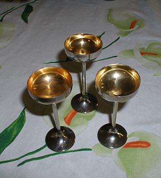 Three little stainless steel drink cups with golden interior