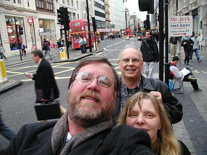 three people looking into the camera on a London street