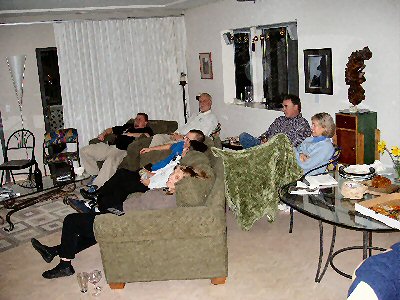 people sitting in living room watching citizen kane on the big screen