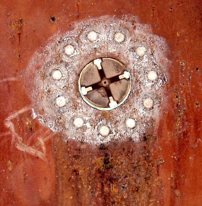 red artwork wheel in bed of rust