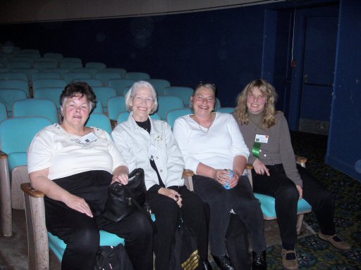 four women sitting in a theater