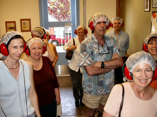 men and women wearing hairnets and red ear noise protectors