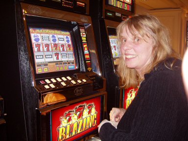 woman at slot machine with all sevens