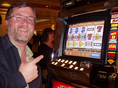 man at slot machine with three bars, three bells, and three dollar signs