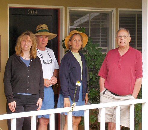 Four people standing at a railing