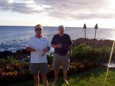two men standing at the rock edge of kauai