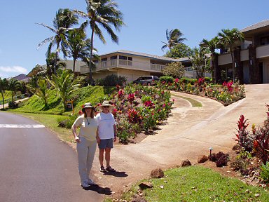 two people standing at the driveway leading up to a house on Pee road, kauai