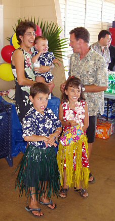 family at a luau with grass skirts