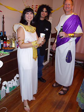 woman in cleopatra costume, man in Roman citizen garb, man dressed in black as Howard Stern