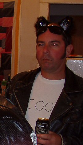 Man wearing leather jacket and cat ears