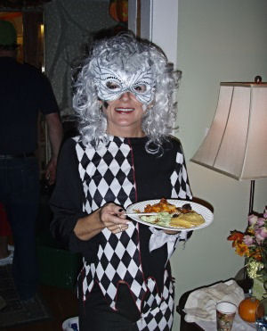 black and white harlequin costume with white wig and mask
