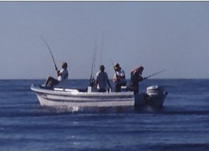 small boat with three fishermen and a captain