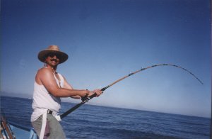 rick with a big fish on his line, pole bent over