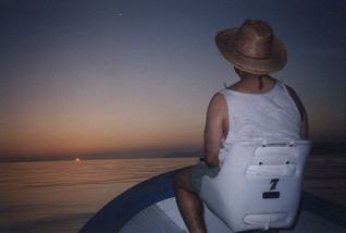 Rick sitting in a skiff watching the sun rise over the Gulf of California