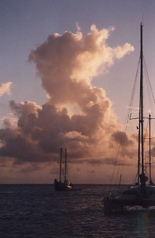 Sunset in Grenada with yacht masts against an angry sky