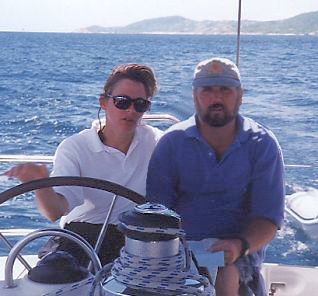 susan and greg at the wheel of the yacht